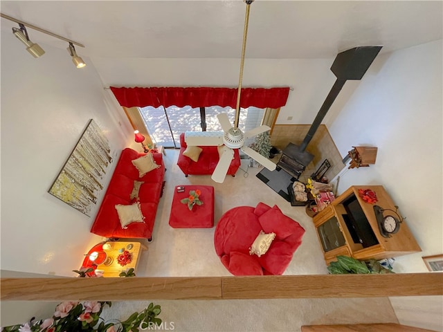 living room with a wood stove and track lighting