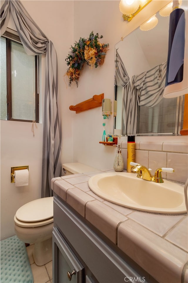 bathroom featuring vanity, toilet, and tile patterned floors