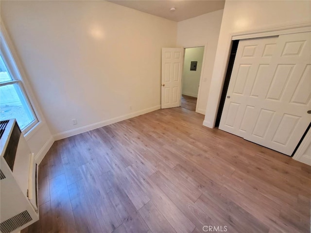 unfurnished bedroom featuring light hardwood / wood-style flooring and a closet