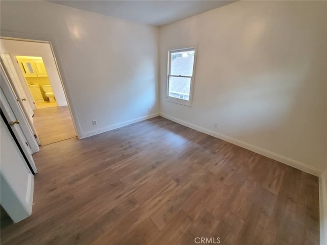 spare room featuring wood-type flooring