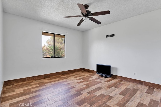 unfurnished room featuring a textured ceiling, hardwood / wood-style floors, and ceiling fan