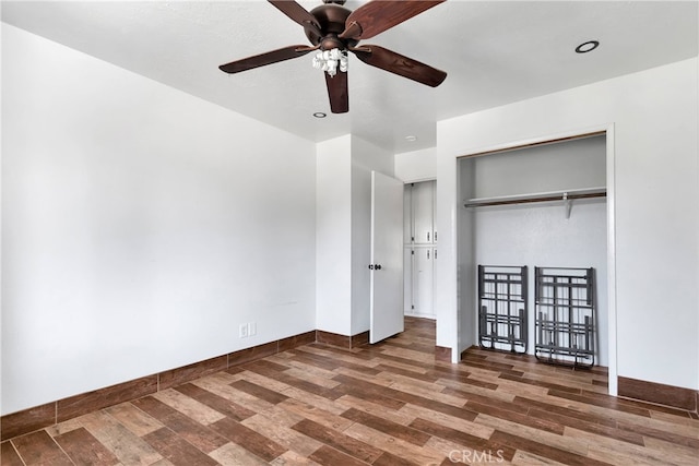 unfurnished bedroom featuring a closet, ceiling fan, and dark wood-type flooring