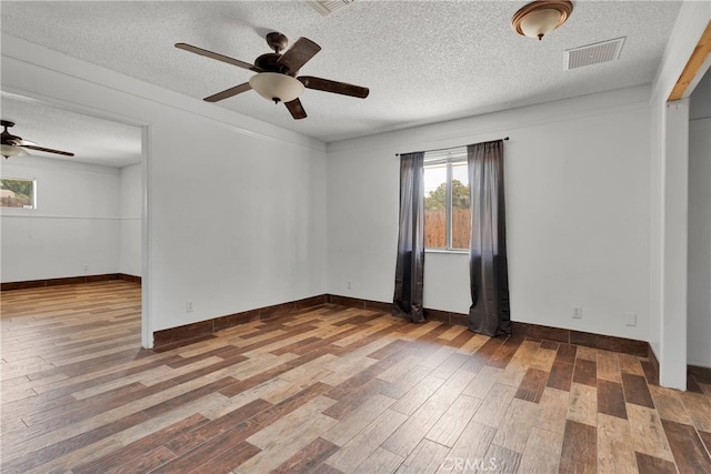 unfurnished room featuring ceiling fan, a textured ceiling, and wood-type flooring