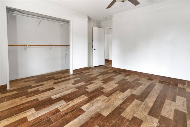 unfurnished bedroom with dark hardwood / wood-style floors, ceiling fan, and a closet