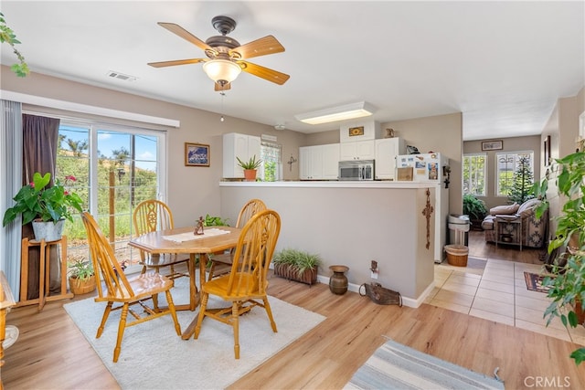 dining room featuring light hardwood / wood-style floors, ceiling fan, and a wealth of natural light