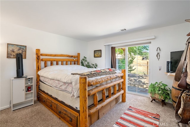 bedroom with carpet and access to exterior