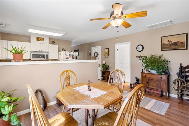 dining space featuring ceiling fan and hardwood / wood-style floors