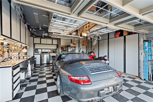 garage featuring a garage door opener and washer / dryer