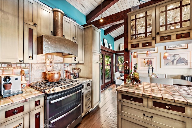 kitchen with wood ceiling, tile countertops, stainless steel range with gas stovetop, and ventilation hood