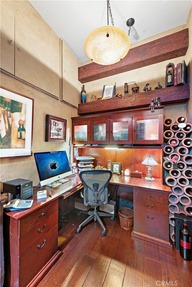 home office featuring built in desk and dark hardwood / wood-style floors