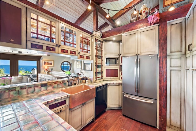 kitchen featuring wood ceiling, beam ceiling, dark wood-type flooring, appliances with stainless steel finishes, and tile countertops