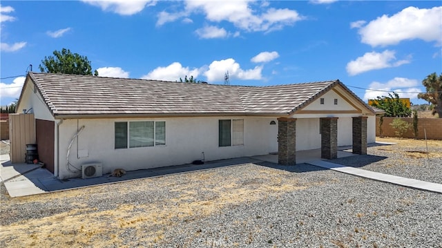 single story home featuring ac unit and a patio area