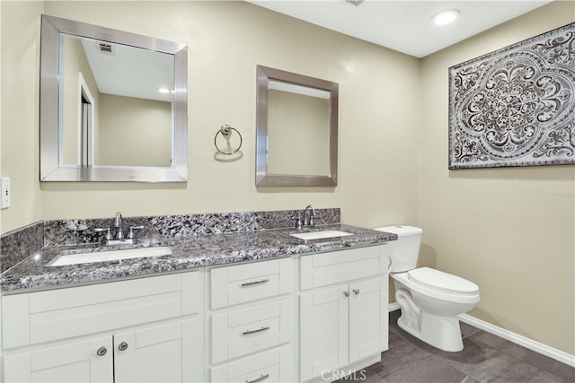 bathroom featuring toilet, vanity, and tile patterned floors