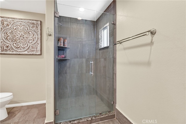 bathroom with toilet and an enclosed shower