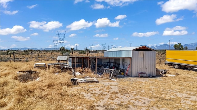 exterior space with an outdoor structure and a mountain view