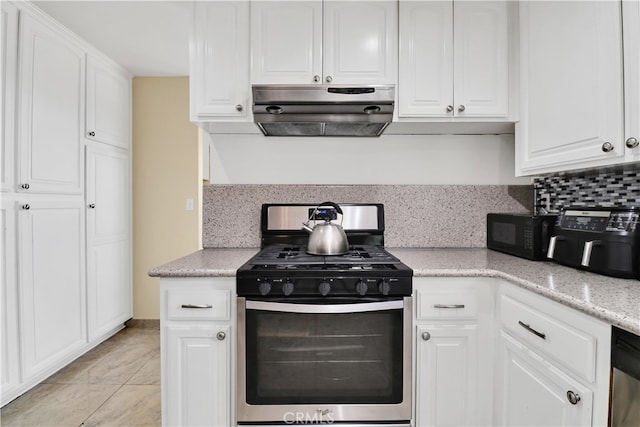 kitchen with white cabinetry, light stone countertops, appliances with stainless steel finishes, and decorative backsplash