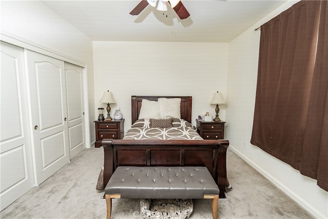 bedroom featuring ceiling fan, light carpet, and a closet