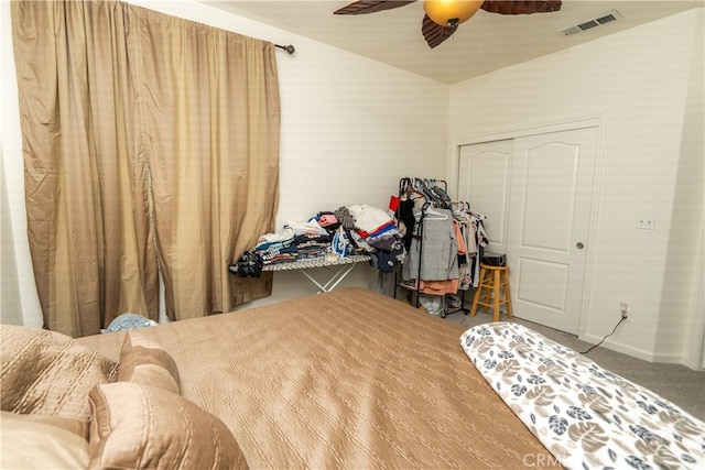 carpeted bedroom with a closet and ceiling fan