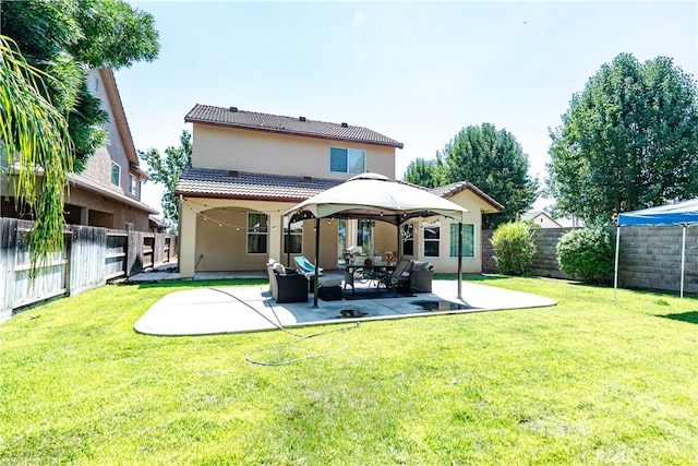 back of property with a patio area and a yard