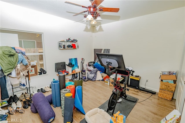 interior space featuring wood-type flooring and ceiling fan