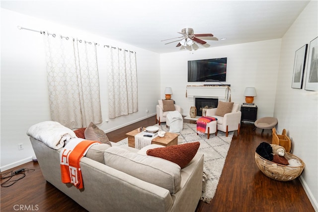 living room with wood-type flooring and ceiling fan