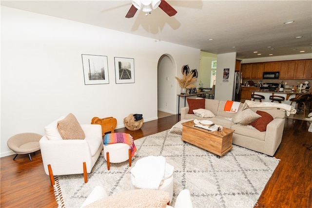 living room featuring ceiling fan and wood-type flooring