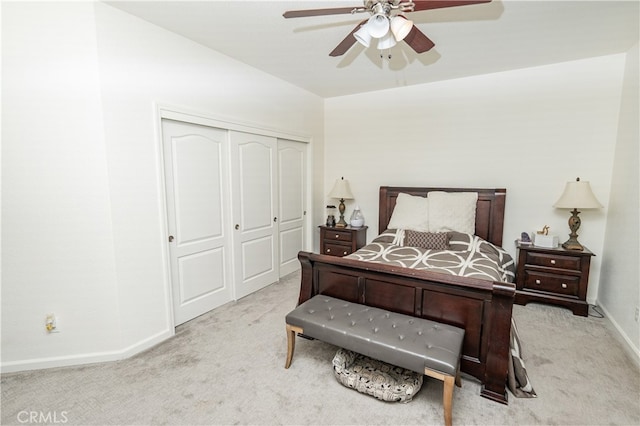 carpeted bedroom featuring a closet and ceiling fan