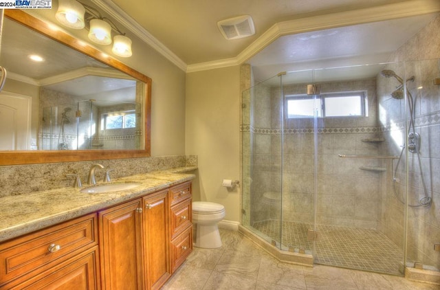 bathroom with vanity, toilet, a shower with door, and crown molding