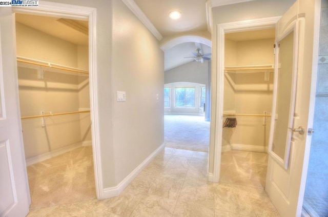 bathroom with ceiling fan, lofted ceiling, and ornamental molding