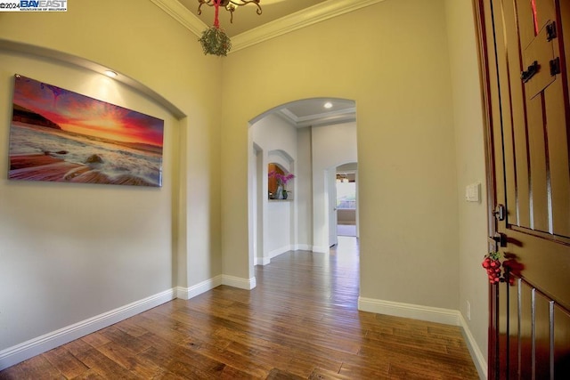 foyer entrance with dark hardwood / wood-style floors and ornamental molding