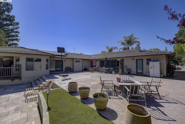 rear view of property featuring a patio area