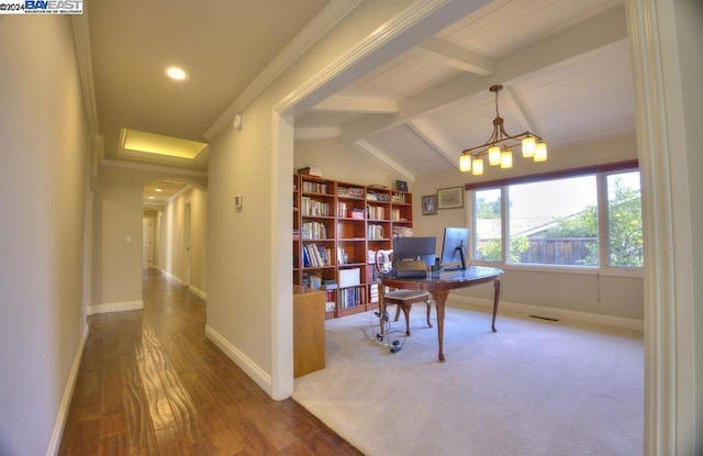 home office featuring vaulted ceiling with beams, an inviting chandelier, ornamental molding, and hardwood / wood-style flooring