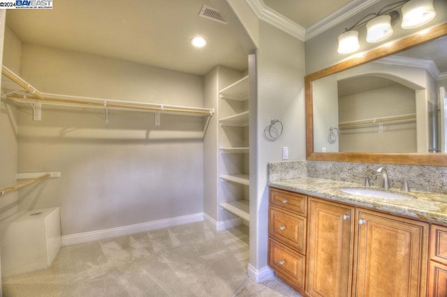 bathroom featuring vanity and ornamental molding