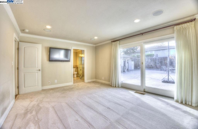 unfurnished room featuring crown molding and light colored carpet