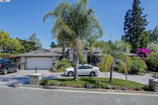 view of front of home with a garage and a front yard