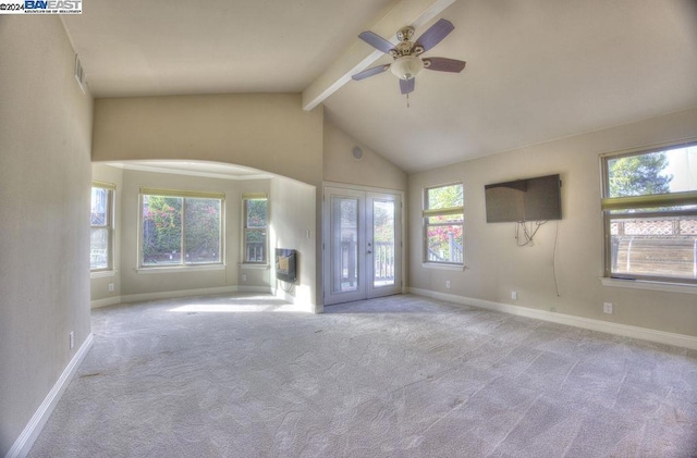 unfurnished living room featuring vaulted ceiling with beams, ceiling fan, light colored carpet, and french doors