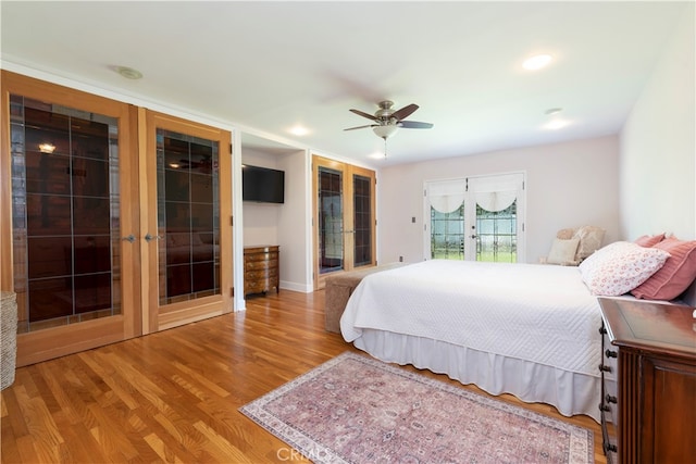 bedroom featuring ceiling fan, light hardwood / wood-style flooring, access to outside, and french doors