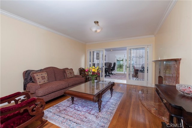 living room featuring wood-type flooring and crown molding