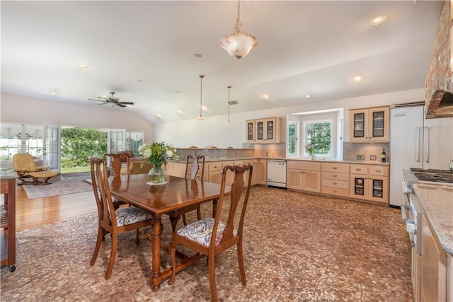 dining space with vaulted ceiling, ceiling fan, and sink