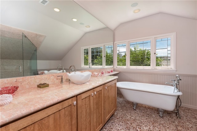 bathroom with vanity, plus walk in shower, and vaulted ceiling