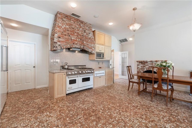 kitchen with stainless steel microwave, backsplash, vaulted ceiling, decorative light fixtures, and range with two ovens