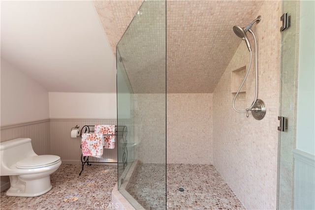 bathroom featuring tile patterned floors, toilet, and walk in shower