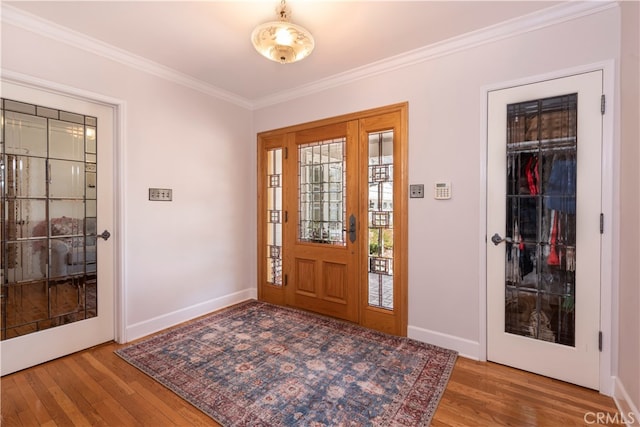 foyer entrance with hardwood / wood-style flooring and ornamental molding