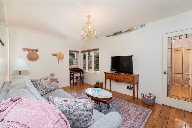 living room with a notable chandelier and wood-type flooring