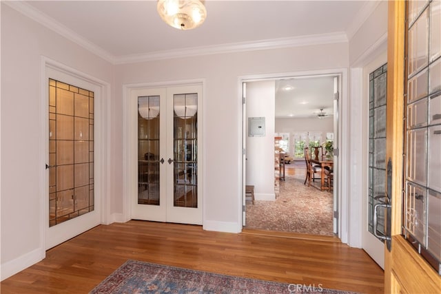 entryway featuring french doors, dark wood-type flooring, and crown molding