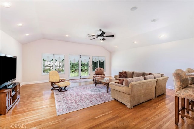 living room featuring french doors, light hardwood / wood-style flooring, ceiling fan, and lofted ceiling