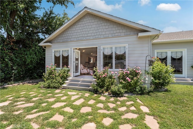 back of house with a lawn