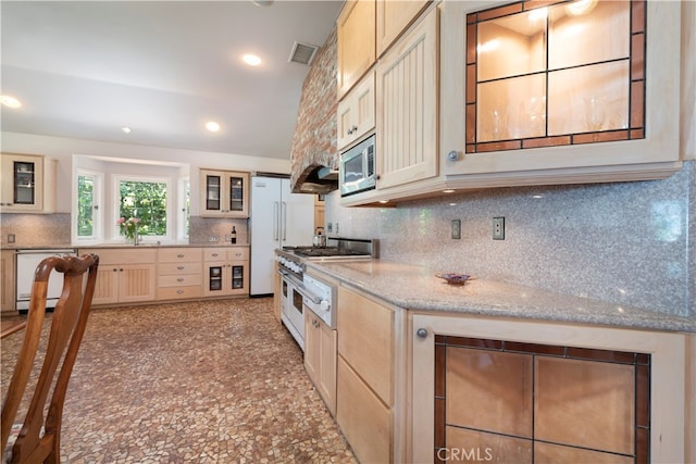 kitchen featuring decorative backsplash, light stone countertops, and appliances with stainless steel finishes