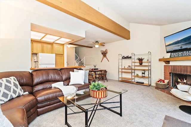 carpeted living room featuring a fireplace, a textured ceiling, ceiling fan, and beamed ceiling