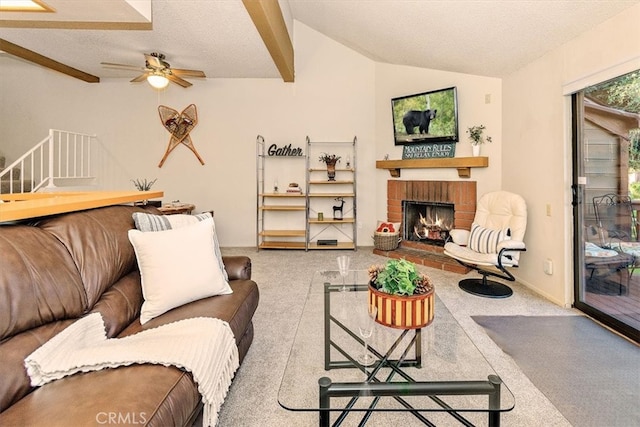 711 Cienega Rd Unit B, Big Bear Lake, CA 92315 - carpeted living room featuring a fireplace, ceiling fan, a textured ceiling, and vaulted ceiling